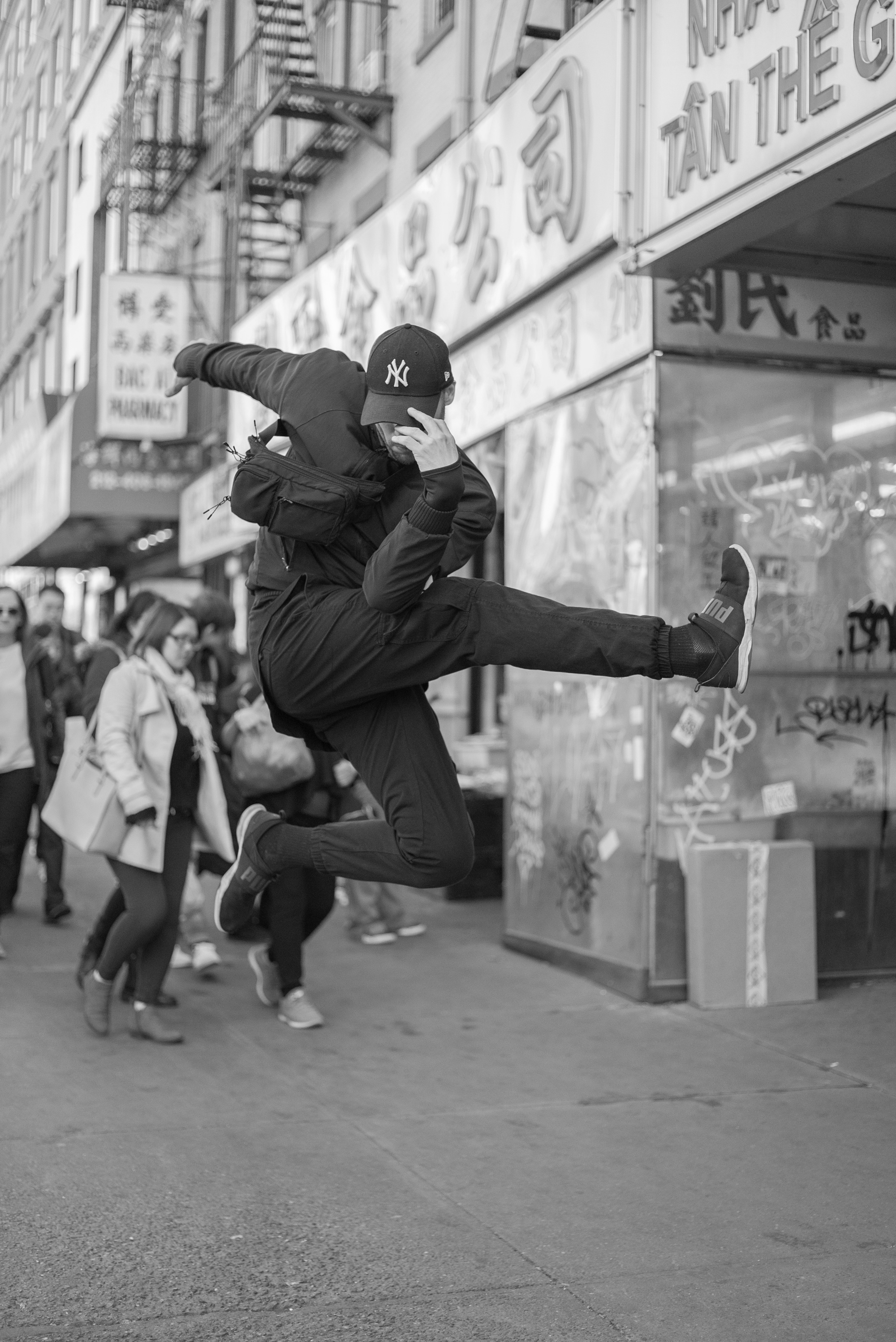 Street Dancer Jumping Pose on China Town Nyc